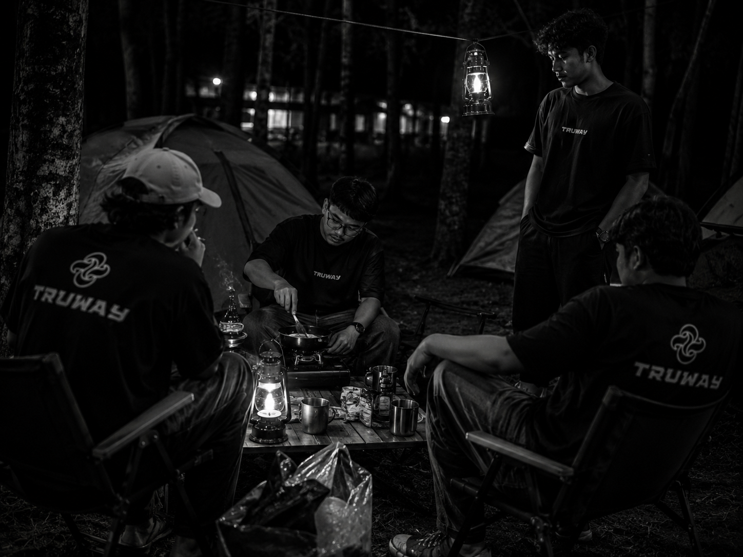 TRUWAY friends cooking together at a night campsite